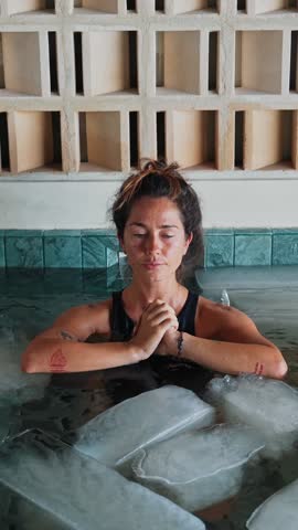 Sportive Woman Dives into Cold Water of Swimming Pool with Ice Cubes for Body Health. Beautiful Person in Bathtub Filled with Frost Liquid for Youth Treat. Winter Routine of Healthy Lady in Floor Bath