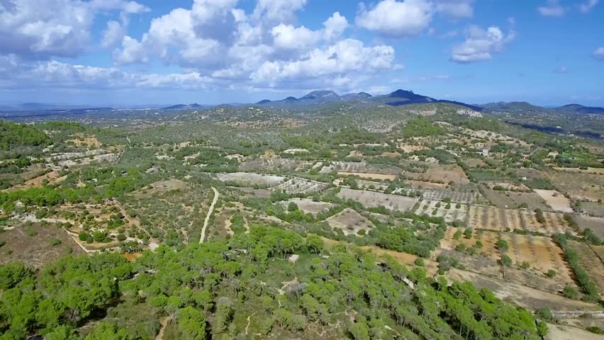 Panoramic View of Cultivated Hilly Landscape under a Cloudy Sky
