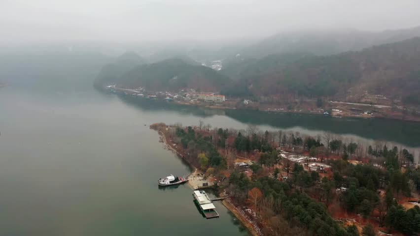 Aerial View of Foggy Lake and Coastal Town in Mountain Valley