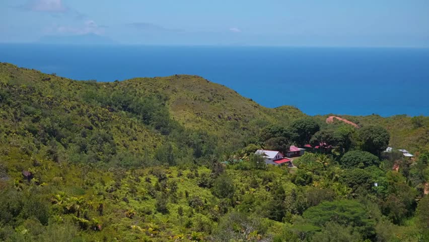 Tropical Island Coastal Landscape with Lush Green Hills and Ocean View