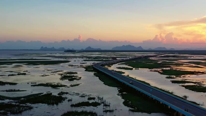 Aerial View of Coastal Highway at Sunset Over Wetlands
