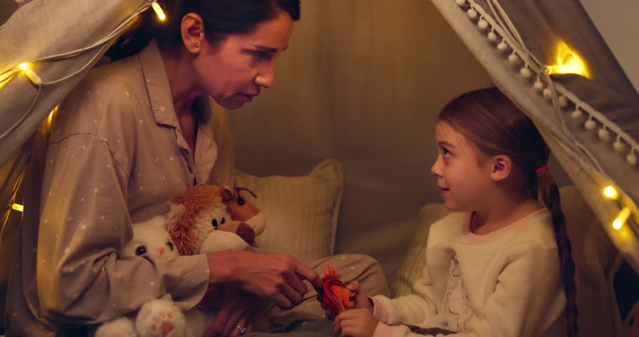 Tent, mom and kid play with toy dinosaur, miniature model and bonding together in family home. Smile, parent and child with stuffed animal for game, learning and explain reptile species at nigh