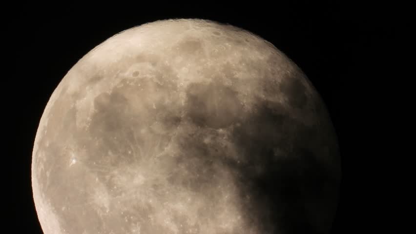 Dark clouds shroud full moon, casting black, eerie, and scary scene