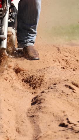 Motorcyclist losing control and falling on dirt