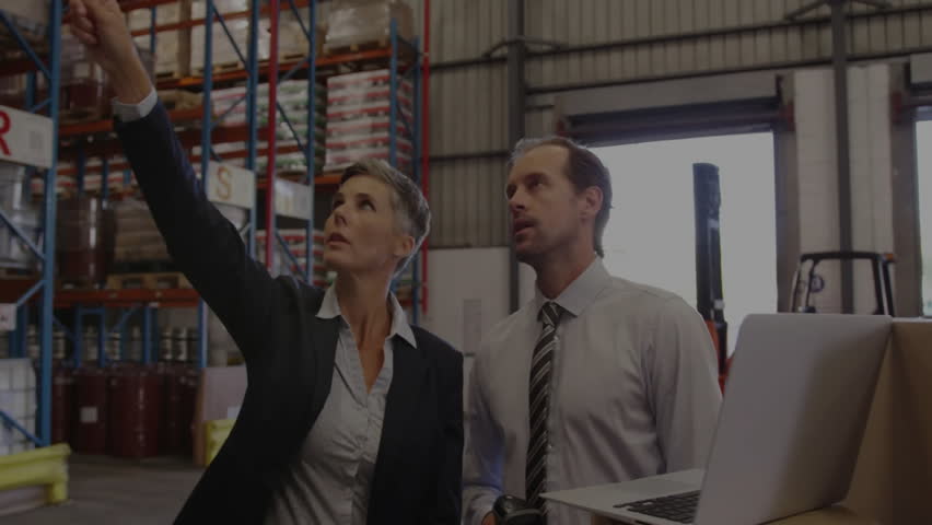 manager pointing racks and operator scanning barcodes initiating hologram overlay guiding restock. Supply chain, logistics, technology, industrial, collaboration, efficiency, data management - Powered by Shutterstock - Get 15% off with code: PIKWIZARD15