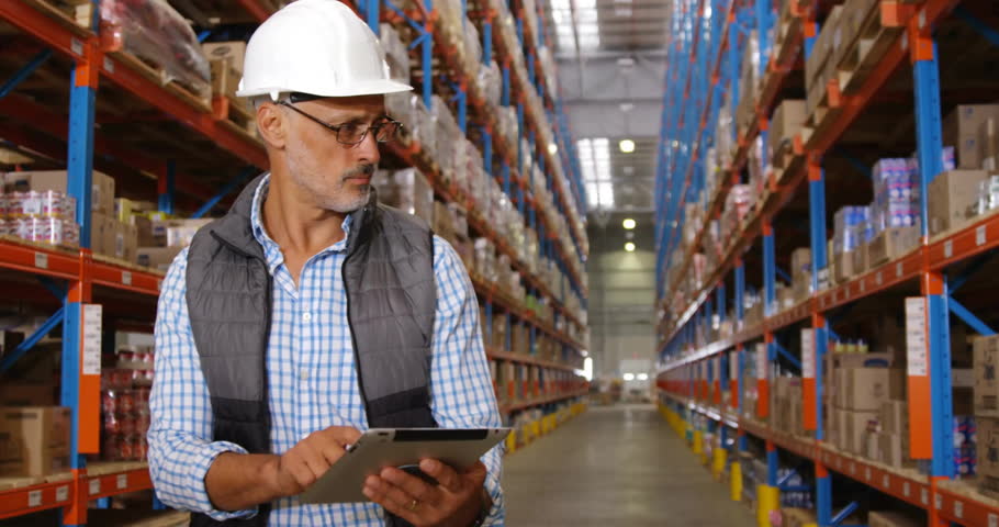 Senior male worker using tablet while notification icons appearing and growing for stock tracking. Industrial, logistics, management, digital, warehouse, technology, supervision