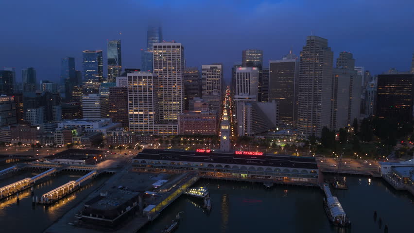 Stunning aerial view of San Francisco at night, highlighting its vibrant skyline and iconic bay, enhanced by swirling fog, creating a magical atmosphere that captivates viewers, California, USA
