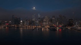 Stunning aerial shot of San Francisco skyline captured beautifully at night with full moon shining, vibrant city lights illuminating the skyline, while iconic fog gracefully rolls in over the bay area - Powered by Shutterstock - Get 15% off with code: PIKWIZARD15