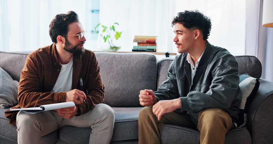 Therapy, writing and therapist with man in office for consulting, counseling session and support. Psychology, mental health and person with patient with notes for diagnosis, listening and help