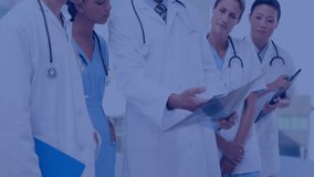 Senior doctor flipping chart film and activating graphs as team reviewing data in hospital corridor. Medical team, collaboration, healthcare, clinical, analysis, diagnostics, data visualization - Powered by Shutterstock - Get 15% off with code: PIKWIZARD15