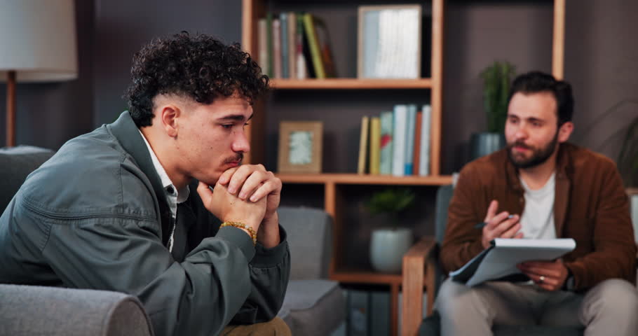 Mental health, psychologist and talking to patient, consultation and appointment for advice and men. Counseling, people and therapist with notebook for progress, trauma and communication in office