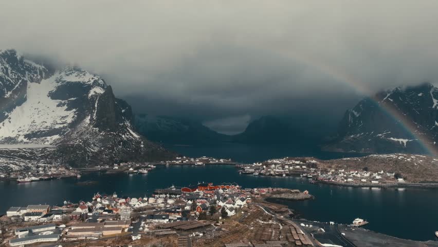 Beautiful Rainbow Over Reine Fishing Village In Nordland, Norway. - aerial shot