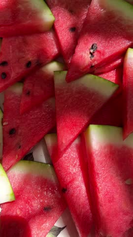 Close-up of triangular watermelon slices with sunlit reflections, capturing fresh, juicy summer vibes and vibrant colors perfect for seasonal, healthy, and tropical themes