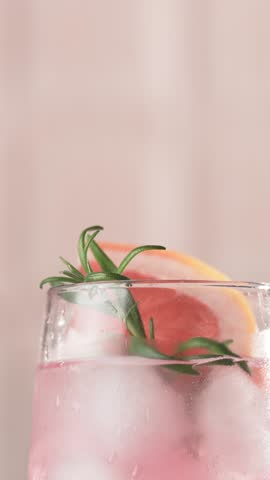 Pink cocktail with grapefruit and rosemary