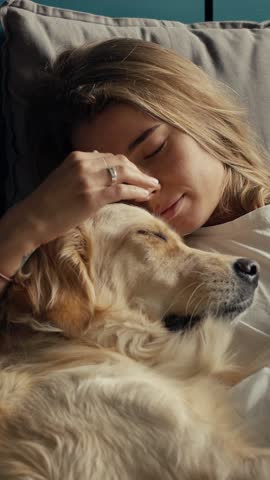 A woman and her golden retriever enjoy a tranquil moment together, embracing warmth and comfort, creating a bond filled with love and joy