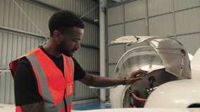 Aircraft maintenance engineer inspecting plane engine in slow motion - Powered by Shutterstock - Get 15% off with code: PIKWIZARD15