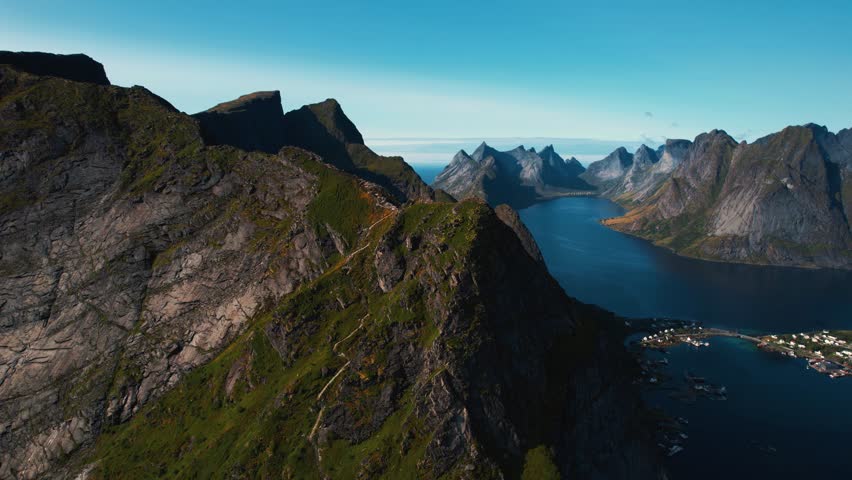 Reinebringen viewpoint above coastal village Reine, Lofoten, Norway. Surrounded by mountains, Arctic sea