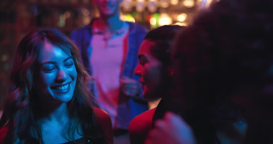 Happy women, friends or dancing at night club for music, energy or party together at event. Female people, group or dancers with smile or celebration for good vibes, disco or late evening rave