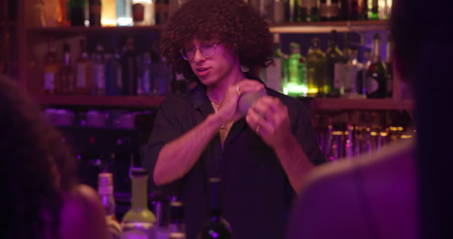 Women, bartender and mixing drinks at a pub for customer, martini or happy hour at counter. Man, mixologist and people with alcohol beverage at bar or nightclub for drinking, social event and party