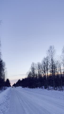 walking on endless road covered with snow in Finland