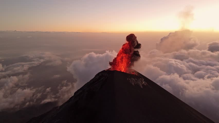 Guatemala active volcano eruption and spitting lava, aerial view