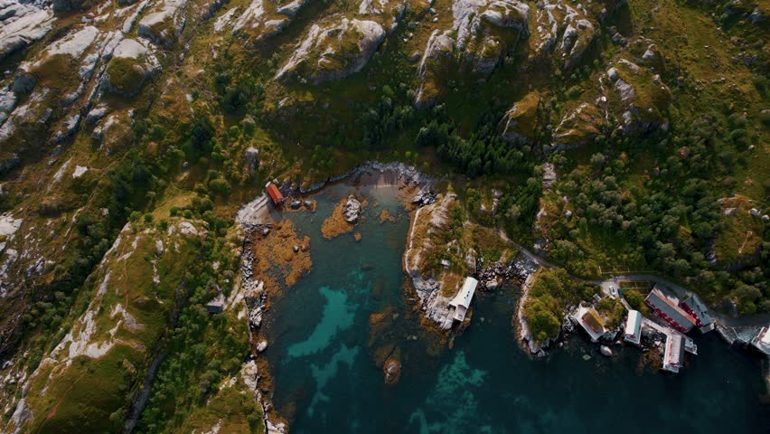 Lofoten Islands scenic aerial above traditional cabins, green nature, turquoise sea, summer landscape