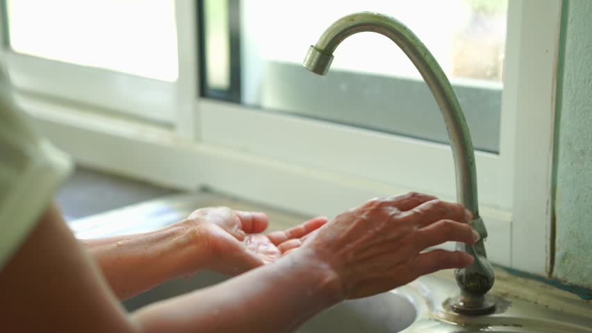 Footage closeup hand washing with alcohol gel or soap for cleaning kill bacteria and disease. Wellness Lifestyle Asian senior woman healthcare. people washing hand water protect virus, Covid 19