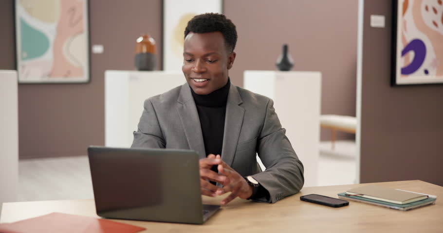 Office, black man and art director with laptop for video call, wave or schedule for exhibition. Museum, business person or curator with tech for talking, gallery project or hello for virtual meeting