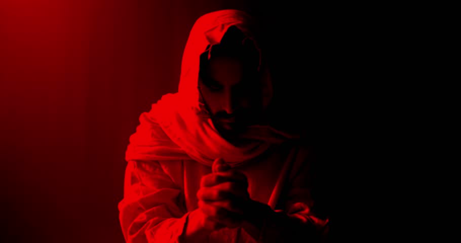 Jesus Christ folding hands and praying. Christianity, Easter visual, bible scene or temptation, prayer, worship visual.