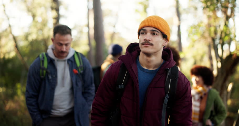 Hiking, man and friends with explore in forest for travel adventure, sightseeing or nature scenery. Backpacker, wellness and group with backpack in woods for holiday journey, fresh air and reflection