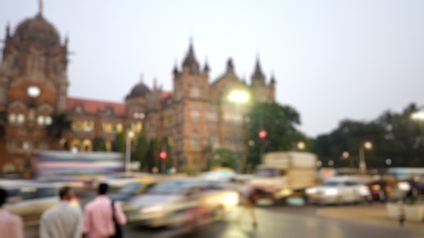 Bokeh view of road traffic near CSMT (Chhatrapati Shivaji Maharaj Terminus) railway station, Mumbai, India. Late evening timelapse, motionlapse. Blurred background footage.