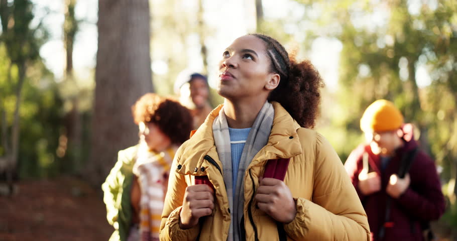 Hiking, woman and friends with walking in forest for travel adventure, explore nature and journey. Backpacker, wellness and group with backpack in woods for sightseeing, fresh air and outdoor scenery