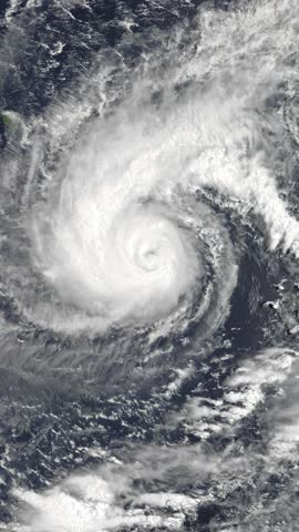 Aerial view on cyclone above ocean. Weather change, bad weather concept. Camera is zooming in, rotating clockwise. Vertical video. Animation based on image by NASA