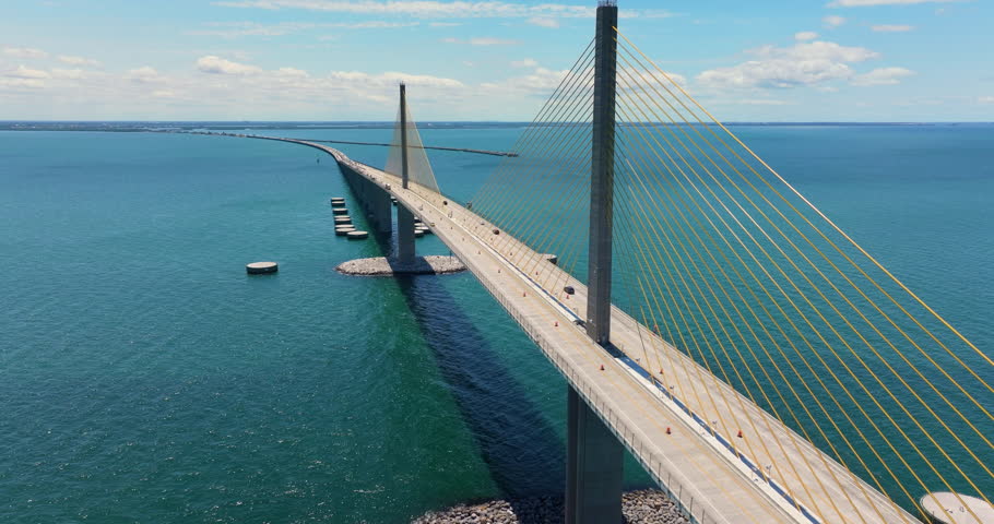 Sunshine Skyway Bridge over Tampa Bay in St Petersburg in Florida with driving traffic cars. Transportation infrastructure in USA