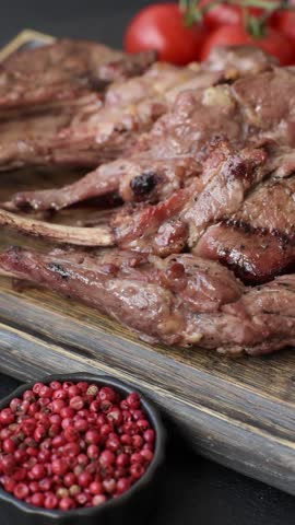 Juicy meat on the bone or rack of lamb. Grilled veal with salt, spices and herbs