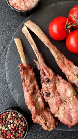 Juicy meat on the bone or rack of lamb. Grilled veal with salt, spices and herbs
