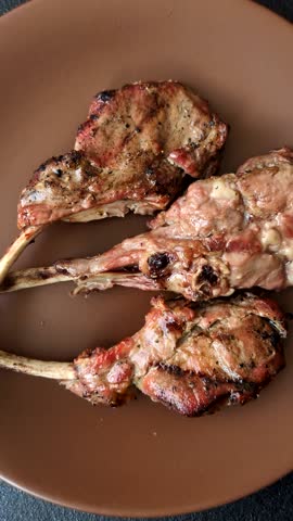 Juicy meat on the bone or rack of lamb. Grilled veal with salt, spices and herbs