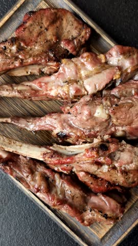 Juicy meat on the bone or rack of lamb. Grilled veal with salt, spices and herbs