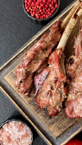 Juicy meat on the bone or rack of lamb. Grilled veal with salt, spices and herbs