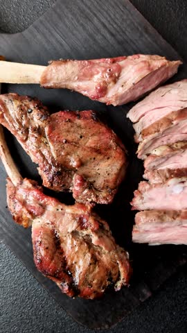 Juicy meat on the bone or rack of lamb. Grilled veal with salt, spices and herbs