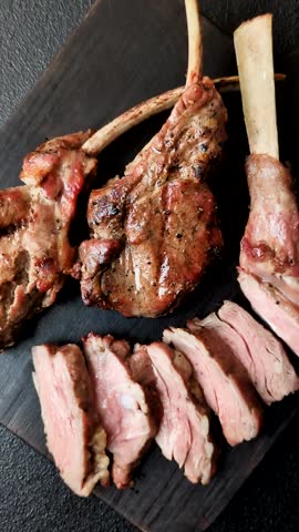 Juicy meat on the bone or rack of lamb. Grilled veal with salt, spices and herbs