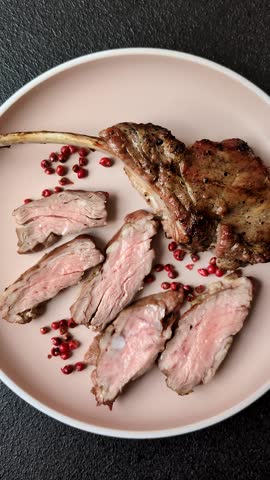 Juicy meat on the bone or rack of lamb. Grilled veal with salt, spices and herbs