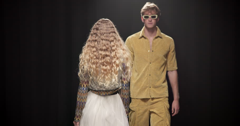 Fashion week, event and designer with man on runway for clothes showcase, luxury industry and outfit. Couture line, trendy wardrobe and catwalk with people walking on stage for style collection