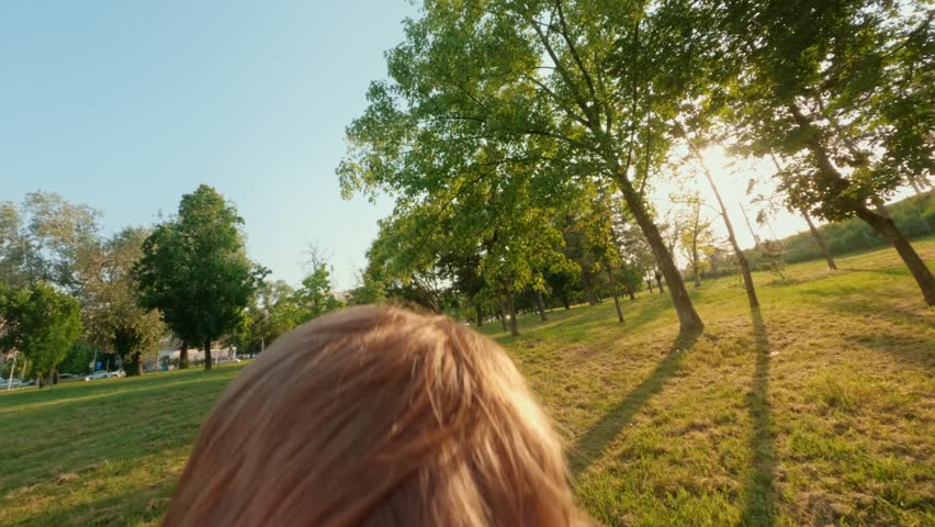 POV view, father tosses high and catches his excited joyful son. Energetic young boy with arms outstretched flying midair against a blue sky, thrown by parent during playful outdoor moment. 