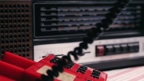 Retro vintage red phone, telephone is displayed on a wooden desk, adding a nostalgic touch. Man answer for call on button 90 phone.  - Powered by Shutterstock - Get 15% off with code: PIKWIZARD15