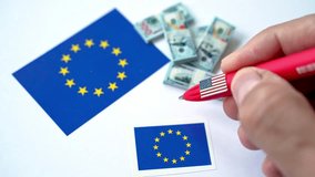 Hand writing 899 act regulation number near European union and USA flag with dollar banknotes, referring to US Tax Law Impacting EU-US Economic Relations - Powered by Shutterstock - Get 15% off with code: PIKWIZARD15
