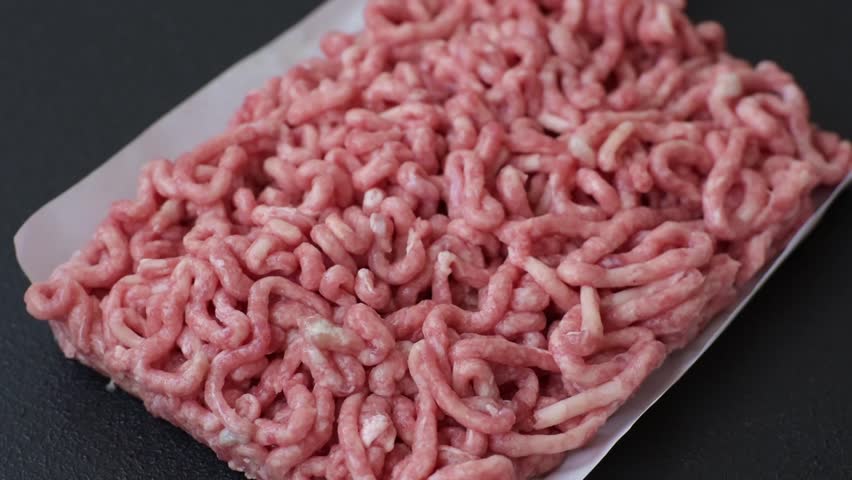 Raw ground beef or pork as an ingredient for burgers. Raw minced meat for cooking at home