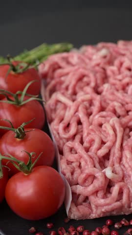 Raw ground beef or pork as an ingredient for burgers. Raw minced meat for cooking at home
