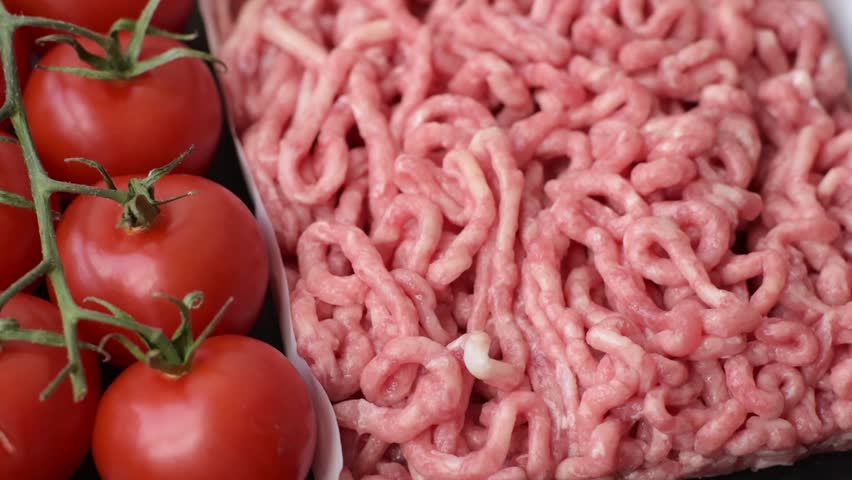 Raw ground beef or pork as an ingredient for burgers. Raw minced meat for cooking at home