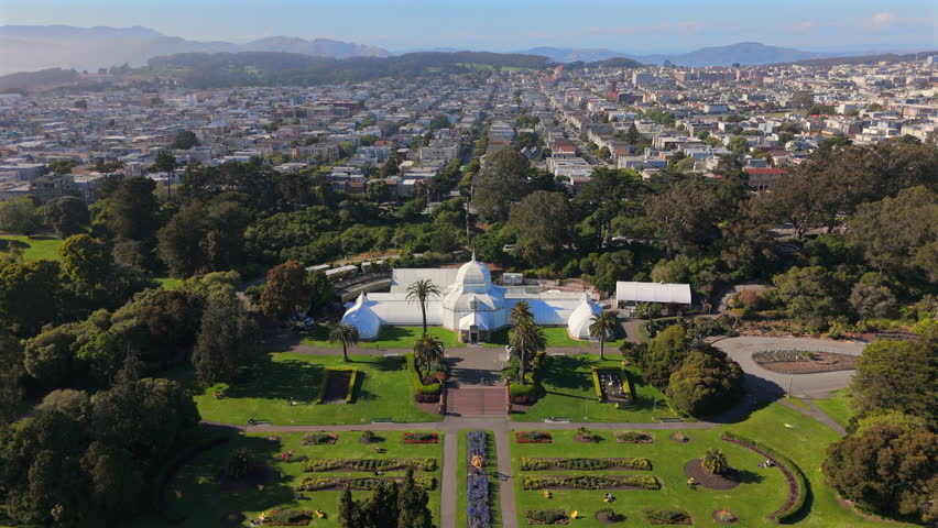 Stunning aerial footage beautifully showcases a vibrant San Franciscos Botanical Garden at Golden Gate park, featuring a unique greenhouse, all set amidst charming neighborhoods of San Francisco
